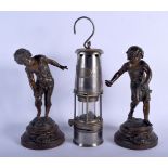 A VINTAGE MINERS LAMP together with a pair of antique spelter figures. 30 cm high. (3)