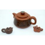 A Yixing teapot decorated with a landscape together with two other smaller examples 14cm (3)