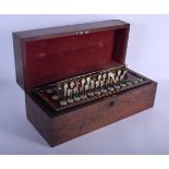 AN ANTIQUE WALNUT INLAID CONCERTINA TYPE INSTRUMENT. 40 cm x 15 cm.