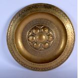 AN ARTS AND CRAFTS BRASS PANEL. 43 cm diameter.