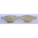 A PAIR OF 19TH CENTURY CHINESE TWIN HANDLED JADE LIBATION CUPS Late Qing. 10.5 cm wide.
