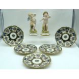 A pair of German Cherub figures and five continental plates decorated with foliage 22cm (7)