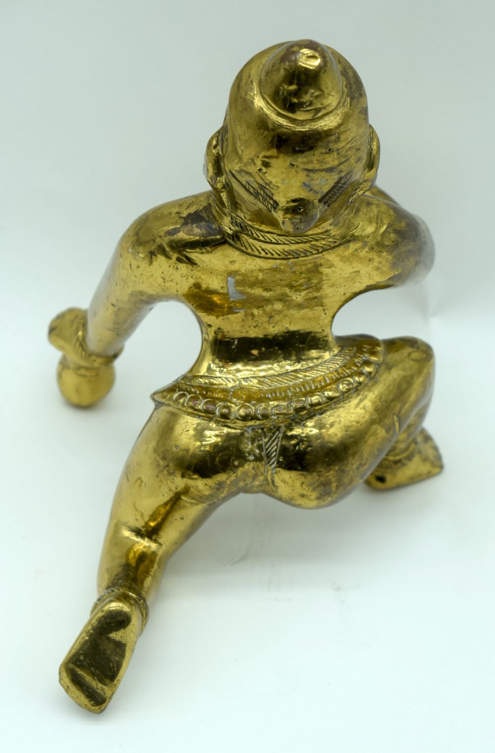 An Indian Bronze figure of a crouching male together with an embossed brass staff head. 39 (2). - Image 3 of 3