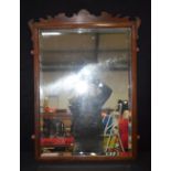 A large wooden framed mirror with bevelled glass 100 x 74cm.