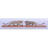 A RARE PAIR OF 19TH CENTURY CONTINENTAL CARVED RHINOCEROS HORN FIGURE OF A ROAMING LION upon a woode