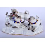 A 19TH CENTURY MEISSEN PORCELAIN FIGURE OF THREE PUG DOGS modelled upon a naturalistic base. 14 cm x