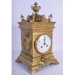 AN ANTIQUE FRENCH BRASS MANTEL CLOCK decorated with mask heads. 37 cm x 15 cm.