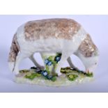 A 19TH CENTURY CONTINENTAL PORCELAIN FIGURE OF A ROAMING LAMB modelled upon a foliate embellished ba