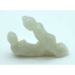 A Chinese carved Jade boulder of a couple copulating 6cm.