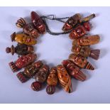 A VINTAGE CONTINENTAL CARVED AND PAINTED MASK WOOD NECKLACE. 28 cm long.