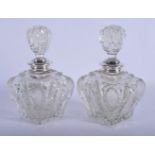 TWO VINTAGE SILVER MOUNTED CUT GLASS SCENT BOTTLES. 17 cm high. (2)