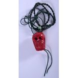 A VINTAGE CHINESE CORAL SKULL PENDANT. 3 cm x 2 cm.