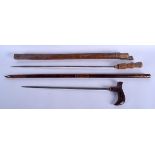 TWO EARLY 20TH CENTURY SOUTH EAST ASIAN SWORD STICKS. 90 cm long. (2)