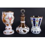 A BOHEMIAN ENAMELLED GLASS GOBLET together with two others. Largest 18 cm high. (3)