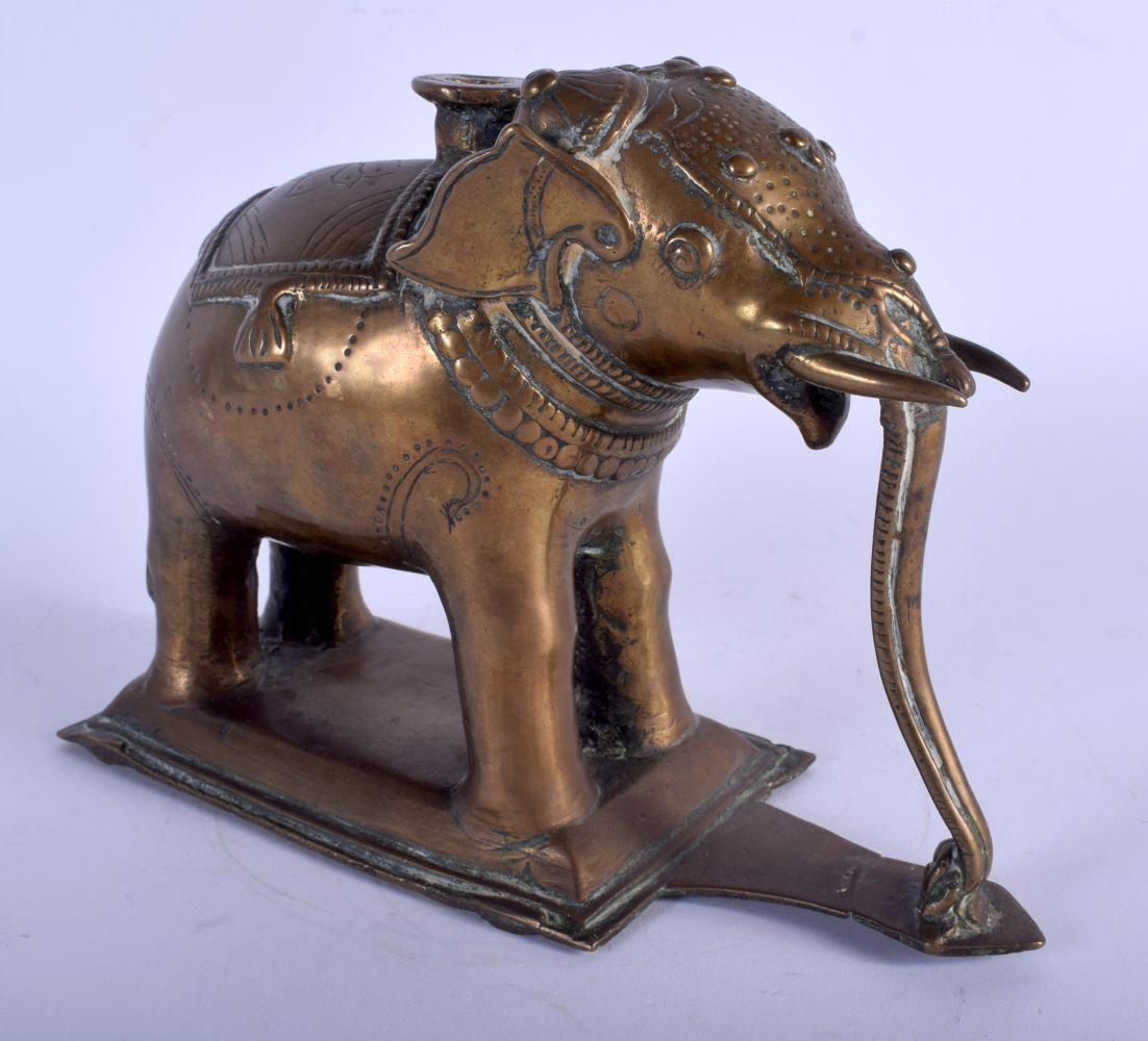 AN 18TH CENTURY INDIAN BRONZE ELEPHANT modelled upon a rectangular base. 15 cm x 20 cm.