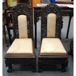 A RARE PAIR OF 19TH CENTURY CHINESE CARVED HARDWOOD HONGMU DRAGON CHAIRS with grape and vine support