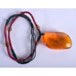 A CHINESE CARVED AMBER BOULDER PENDANT 20th Century. 30 grams. 6 cm x 4 cm.