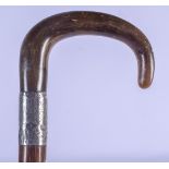 A 19TH CENTURY CONTINENTAL CARVED RHINOCEROS HORN HANDLED WALKING CANE with silver mounts. 88 cm lon