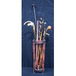 A collection of walking sticks, golf club, umbrella etc together with a stick stand 120cm (13).