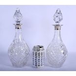 A PAIR OF 1970S ENGLISH MOUNTED SILVER DECANTERS AND STOPPERS. London 1972. 32 cm high.