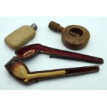 A carved treen nutcracker together with a pipe and a small flask 24cm (3).