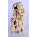 A 19TH CENTURY JAPANESE MEIJI PERIOD CARVED IVORY OKIMONO modelled as a male and child. 9 cm x 3.5 c