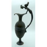 A bronze water/wine jug with an unusual winged woman handle. 48cm.