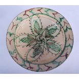 AN EARLY 20TH CENTURY IRANIAN PERSIAN TIN GLAZED POTTERY BOWL painted with leaves. 30 cm diameter.