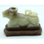 A carved Jadeite boulder carved as a Ram with a lid on a wooden stand 11cm (2).