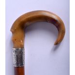 A 19TH CENTURY CONTINENTAL CARVED RHINOCEROS HORN WALKING CANE with silver mounts. 88 cm long.