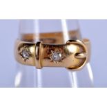 AN 18CT GOLD AND DIAMOND BUCKLE RING. 3.7 grams. N.