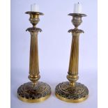 A PAIR OF 19TH CENTURY FRENCH GILT METAL CANDLESTICKS Empire style. 25.5 cm high.