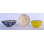 TWO CHINESE MING DYNASTY DISHES together with a yellow bowl. Largest 13 cm diameter. (3)