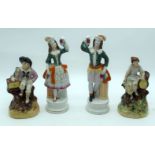 A pair of Staffordshire figures together with two figures 24cm (4).