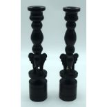 A pair of carved Ebony elephant candle stick holders 27cm. (2)