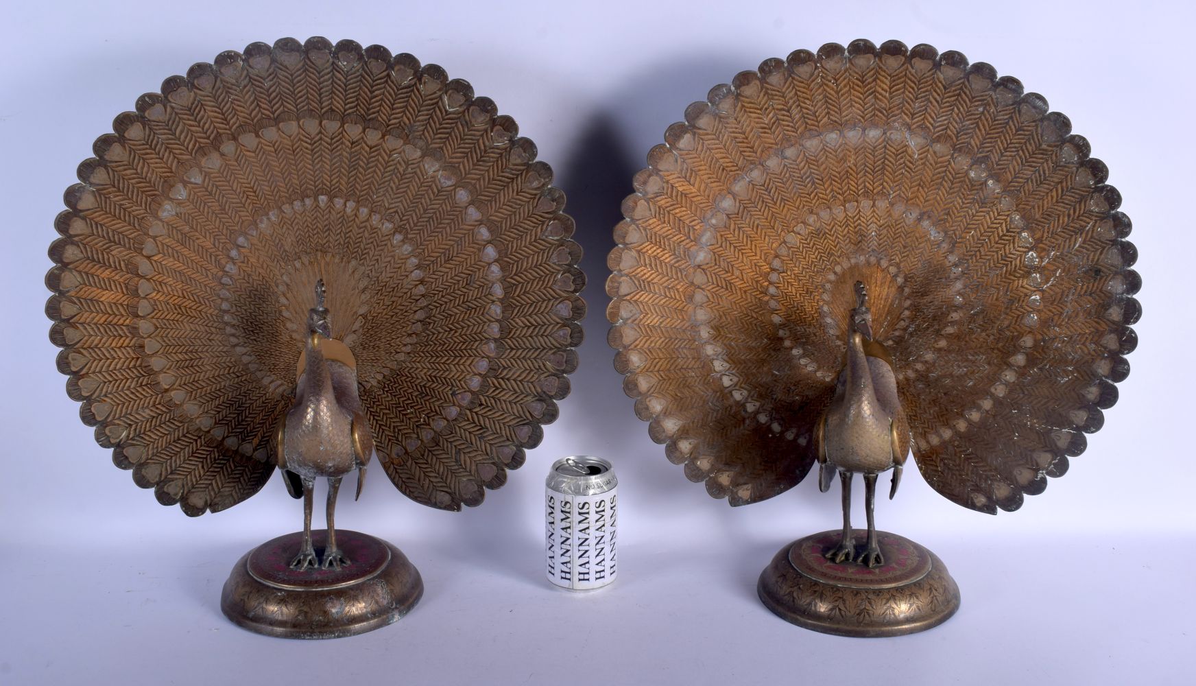 A RARE LARGE PAIR OF EARLY 20TH CENTURY INDIAN ENAMELLED BRASS PEACOCKS upon circular bases decorate