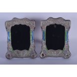 A PAIR OF SILVER AND ENAMEL PHOTOGRAPH FRAMES. 21 cm x 16 cm.