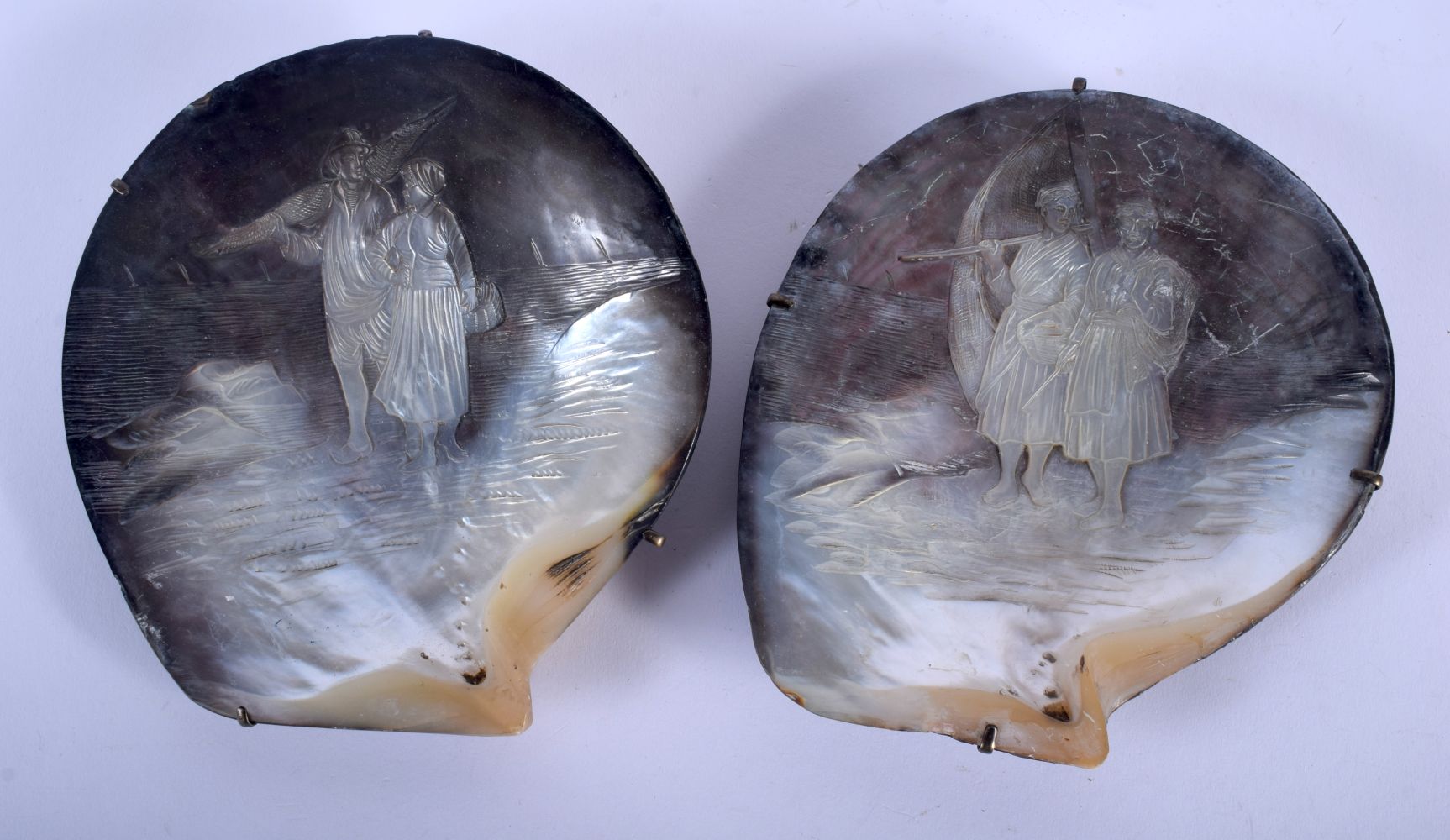 A PAIR OF 19TH CENTURY EUROPEAN CARVED MOTHER OF PEARL SHELLS decorated with a fisher man and fisher