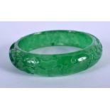 A CHINESE CARVED SPINACH JADE BANGLE 20th Century. 6.5 cm wide.