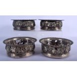 A SET OF FOUR ANTIQUE SILVER PLATED VINE LEAF AND BERRY BOTTLE COASTERS. 16 cm x 6 cm. (4)