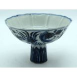 A Chinese blue and white stem cup decorated with fish. 17 x 11cm.