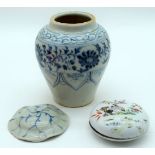 A small Chinese blue and white vase decorated with foliage together with a porcelain lidded pot and