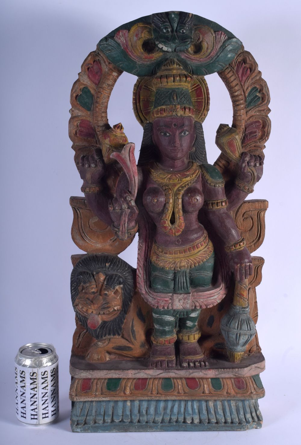 A LARGE INDIAN CARVED POLYCHROMED WOOD FIGURE OF FOUR ARMED DURGA modelled with a lion behind her. 5