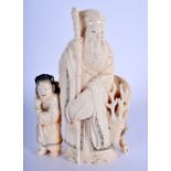 A 19TH CENTURY JAPANESE MEIJI PERIOD CARVED IVORY OKIMONO modelled as sage beside a deer. 15 cm x 8