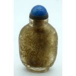 A Chinese glass snuff bottle carved with a dragon 10cm