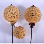 A PAIR OF 19TH CENTURY CHINESE CARVED HORN HAIR PINS together with another smaller ball. Largest 14