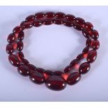 A VINTAGE AMBER TYPE NECKLACE. 53 grams. 56 cm long, largest bead 3 cm x 2 cm.