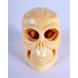 A CHINESE CARVED BONE SKULL 20th Century. 3 cm x 2 cm.