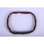 AN EARLY 20TH CENTURY CHINESE CARVED HORN BEADED NECKLACE possibly Rhinoceros, of graduated form. 44
