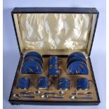 A CHARMING BOXED SET OF WEDGWOOD SILVER MOUNTED LUSTRE PORCELAIN TEACUPS painted with fish, the spoo